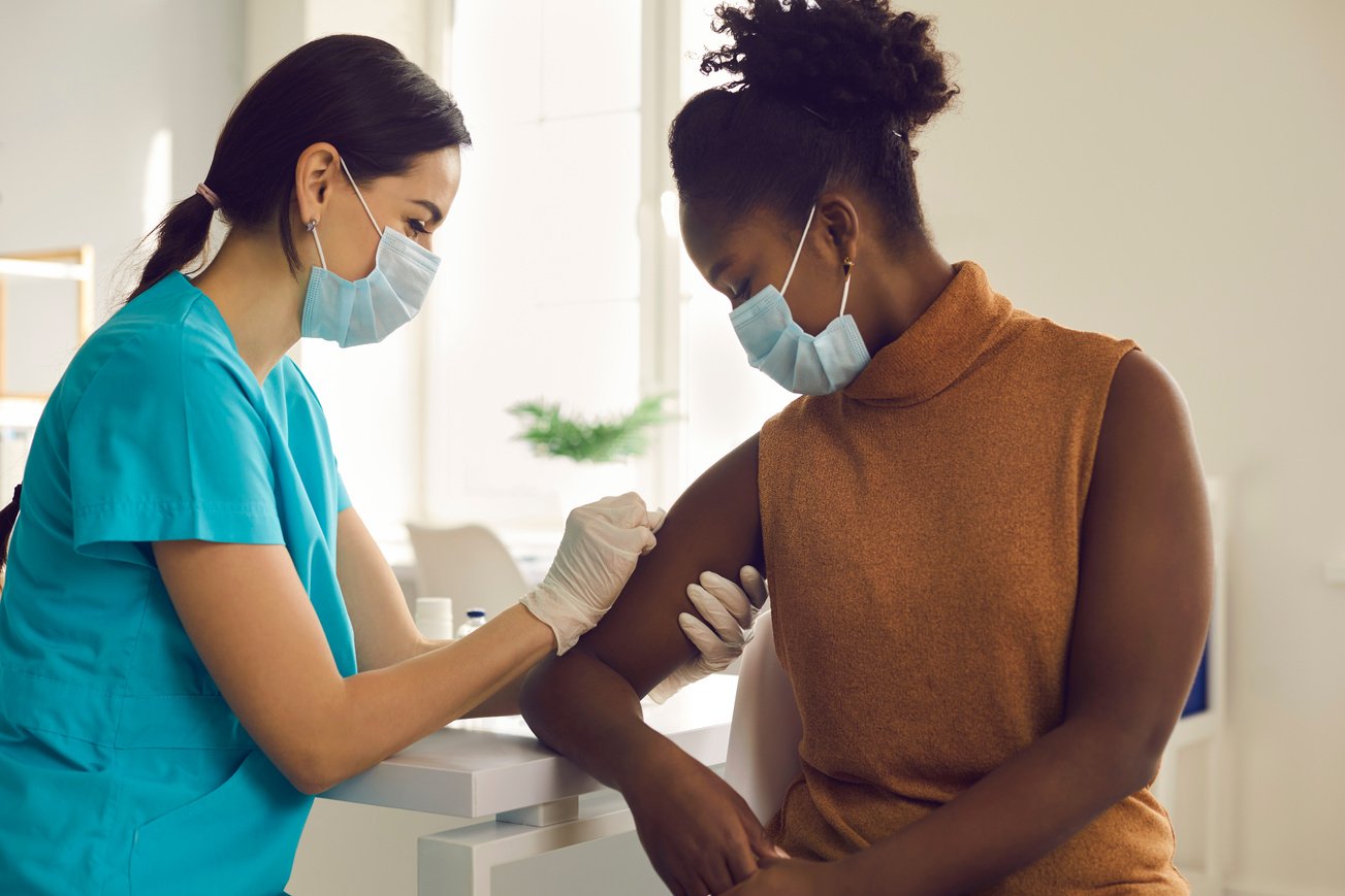 Young African-American Woman Getting Seasonal Influenza Shot or Modern Covid-19 Vaccine